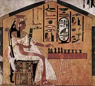 Painting in tomb of Egyptian queen Nefertari playing a board game (commonly identified as senet) on a game board with game pieces, c. 1295–1255 BCE