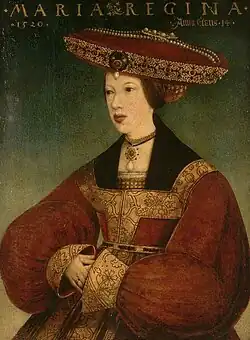 Mary wearing a dark brown dress and a tan head covering