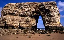 Picture of Marsden Rock in 1990. The arch was formed by erosion of the limestone rock by waves and weather.