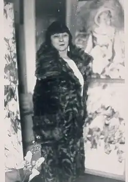 Jacqueline Marval standing among paintings in her apartment, Paris circa 1925