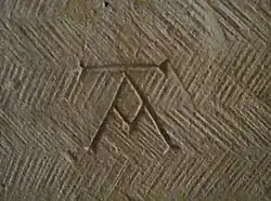 Mason's mark in the Église Saint-Honorat&nbsp;[fr] in Alyscamps, France, early 13th century