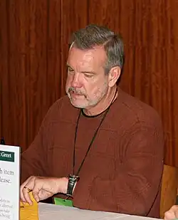 McCarren signing autographs at a table