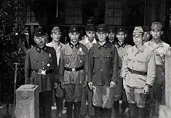 A black-and-white photograph of several men in uniform.