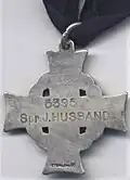 Reverse side of the cross, engraved with name of deceased
