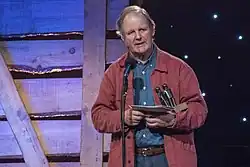 Michael Morpurgo on stage accepting an award.
