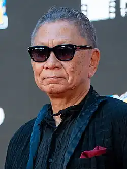 cropped headshot of Miike wearing sunglasses at Tokyo International Film Festival 2023
