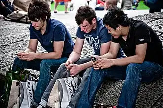 Young men in London, 2010, wearing slim-cut jeans and layered T-shirts and polos, typical of middle-class streetwear influenced by Abercrombie & Fitch.