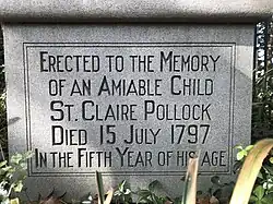 Monumental inscription carved into stone on monument.