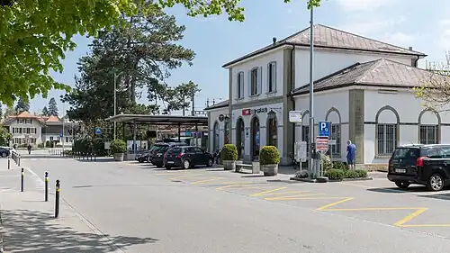 Two-story building with hip roof and single-story wings