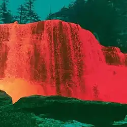 A color-inverted photograph of a waterfall