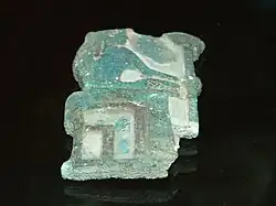 Fragmentary relief of green glaze showing a woman seated