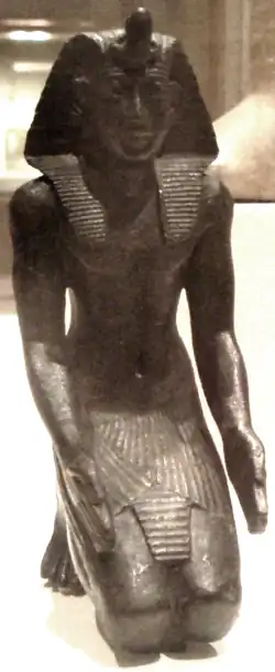 A small kneeling bronze statuette, likely Necho&nbsp;II, now residing in the Brooklyn Museum