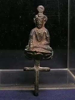 Nestorian Christian statuette probably from Imperial China, a bodhisattva-like figurine seated on a cross, probably Mongol dynasty (1271–1368).
