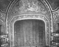 Black-and-white image of the auditorium's proscenium arch, which contains murals
