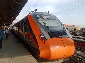 NJP-HWH Vande Bharat Express at New Jalpaiguri Junction railway station. It's also worth mentioning that the train has been re-painted from its old white and blue livery to the new saffron and black livery.