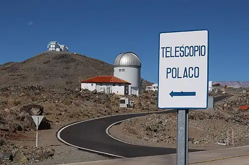 Sign to the OGLE telescope. Twin 6.5-meter Magellan Telescopes are seen in the background