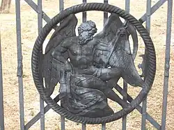 Detail of the "Father Time" medallion on the burial ground's wrought iron gates