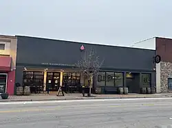 A long grey building with a sunk-in entrance
