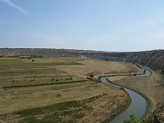 River winding past low farmland