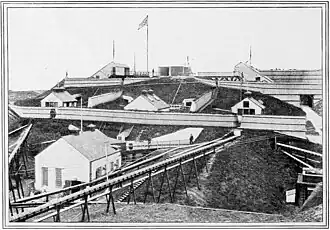 Exterior view of the nitro-glycerine hill. Note the gutters used to enable the flow of nitroglycerine downhill, 1893