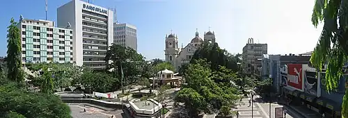 A view of a public square surrounded by buildings and decorated with trees