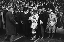 Louis Cler carrying the Coupe de France trophy.