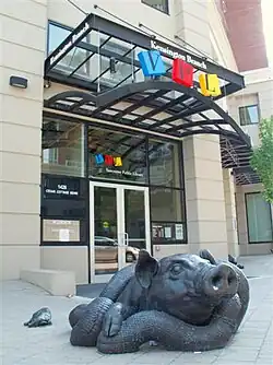 brass sculpture of a pig and a snake