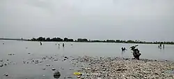 Local residents bathing in the shallow waters of the Indus River at Hund village—a regular activity during summer mornings.