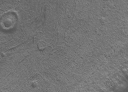 Close up image of Phaethontis surface taken with Mars Global Surveyor. Holes are thought to be caused by buried ice turning into a gas.