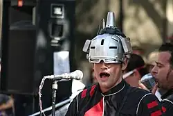 Joebot wearing a silver helmet.