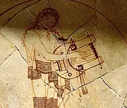 Round-based lyre, a phorminx played by a muse.