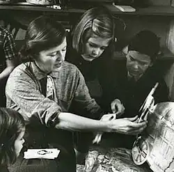 Fitzgerald shows her children paper dolls that her mother, Zelda, made for her. From the February 1959 Life Magazine issue by Robert Phillips.