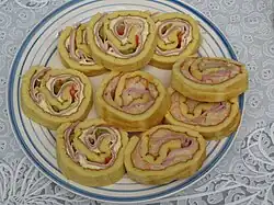 Sliced Savory Argentine pionono, with Ham, cheese, Salsa golf and vegetables