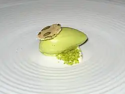 Pistachio ice cream over whipped mascarpone topped with pistachio biscotti