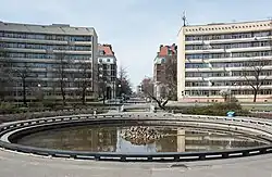 Two buildings added in 1960 by Zofia Fafius, with architecture differing from the rest of the estate, seen from the fountain side on the Crossroads Square