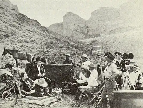 Publicity still of cast and crew on location