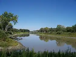The Red River near Pembina, North Dakota, about 3 kilometres (2&nbsp;mi) south of the Canada–U.S. border. The Pembina River can be seen flowing into the Red at the bottom.