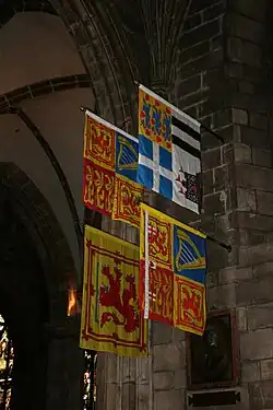 The Royal Standard of the United Kingdom used in Scotland and (clockwise) those of the Prince Philip, Duke of Edinburgh, Anne, Princess Royal (Scottish variant) and Duke of Rothesay, displayed in St Giles's Cathedral, Edinburgh.
