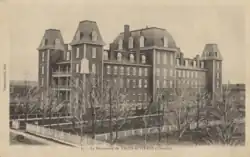 A black-and-white photo of a building housing a scholarly institution