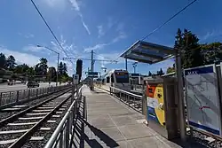 A MAX train stopped on the middle tracks of SE Park Ave station