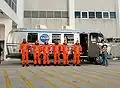 Melvin (center) with STS-129 crew members boarding the astrovan