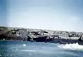 Damaged landing craft on beach, 1945
