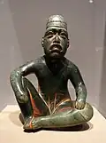 Seated shaman in ritual pose-shaped pendant (Olmec); 9th-5th century BC; serpentine and cinnabar; height: 18.5&nbsp;cm; Dallas Museum of Art (Dallas, Texas, US)[68]