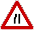 Road narrows on left side