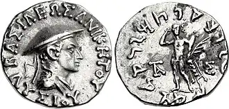 Silver coin of Lysias. Obverse shows the king wearing a kausia hat and the royal diadem, with the Greek legend: ΒΑΣΙΛΕΩΣ ΑΝΙΚΗΤΟΥ ΛΥΣΙΟΥ, Basileōs Anikētou Lysiou. Reverse with standing Heracles, and Kharosthi legend: Maharajasa Apadihatasa Lisiasa, "Of the Great Invincible King Lysias".