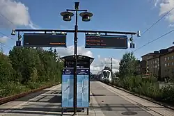 Platform at Skogås with X60 train in the background.