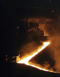 Molten slag flowing into a channel, exiting a Martin-Siemens converter in 1941.
