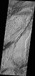 Southern end of Enipeus Vallis is about 10&nbsp;km wide and broadly U-shaped in profile. The western wall of the valley has a straight NE orientation similar to that of fractures in the Noachian plateau materials to the east. This suggests that the valley formed along pre-existing faults. (THEMIS VIS image)