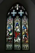 Gothic Revival stained glass window in the church representing Jesus as the Good Shepherd