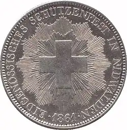 Swiss Cross surrounded by rays. Legend along edge.